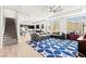 Open-concept living room with a large sectional sofa, wood floors, and staircase at 245 Hull St, Henderson, NV 89015