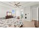 Main bedroom featuring tiled floors, a ceiling fan, and access to the main bathroom at 245 Hull St, Henderson, NV 89015
