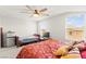 Spacious main bedroom featuring a ceiling fan, large windows, and a full-sized bed at 245 Hull St, Henderson, NV 89015