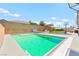 Refreshing swimming pool with lounge chairs and outdoor entertainment area in a private backyard at 245 Hull St, Henderson, NV 89015