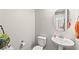 A well-lit powder room featuring a pedestal sink, and a toilet at 245 Hull St, Henderson, NV 89015