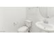 Bathroom featuring a pedestal sink, toilet, and a round mirror at 2495 Sunflower Days Ave # 2052, North Las Vegas, NV 89031