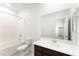 Bathroom with a large mirror, dark wood cabinets, and shower-tub combo at 2495 Sunflower Days Ave # 2052, North Las Vegas, NV 89031