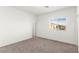 Bright bedroom with neutral carpet, a large window and closet door at 2495 Sunflower Days Ave # 2052, North Las Vegas, NV 89031