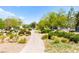 Community park with a stone walking path and lush landscaping at 2495 Sunflower Days Ave # 2052, North Las Vegas, NV 89031