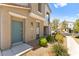 Two-story home features a blue front door and well-maintained landscaping at 2495 Sunflower Days Ave # 2052, North Las Vegas, NV 89031