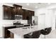 Modern kitchen features stainless steel appliances, granite countertops and dark wood cabinetry at 2495 Sunflower Days Ave # 2052, North Las Vegas, NV 89031