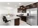 Stylish kitchen features granite counters, stainless appliances, dark cabinetry and breakfast bar with seating at 2495 Sunflower Days Ave # 2052, North Las Vegas, NV 89031