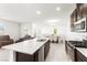Open-concept kitchen with granite counters, stainless appliances, and seamless flow to dining and living areas at 2495 Sunflower Days Ave # 2052, North Las Vegas, NV 89031