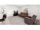 Cozy living room with plush carpeting, comfortable seating, and a media center, bathed in natural light at 2495 Sunflower Days Ave # 2052, North Las Vegas, NV 89031