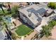 Aerial view of house and lush backyard with a private pool, spa, well-manicured lawn, and solar panels at 2500 Wimbledon Dr, Las Vegas, NV 89107