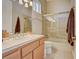 Bright bathroom with a shower-tub combo, tile flooring, and vanity with lots of storage at 2500 Wimbledon Dr, Las Vegas, NV 89107