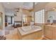 Bathroom featuring a large soaking tub, fireplace, and dual vanities with tile floors at 2500 Wimbledon Dr, Las Vegas, NV 89107