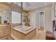 Bathroom with soaking tub, glass block window, dual vanities, and tile flooring at 2500 Wimbledon Dr, Las Vegas, NV 89107