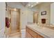 Bright bathroom with a glass enclosed shower, tile flooring, and vanity with lots of storage at 2500 Wimbledon Dr, Las Vegas, NV 89107
