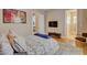 Neutral bedroom with a TV on the wall, hardwood flooring, and an ensuite bathroom at 2500 Wimbledon Dr, Las Vegas, NV 89107