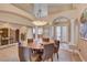 Elegant dining room featuring a modern chandelier, spacious layout, and graceful archways at 2500 Wimbledon Dr, Las Vegas, NV 89107