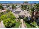 Aerial view of the home showcasing mature trees, a manicured lawn, and a classic front elevation at 2500 Wimbledon Dr, Las Vegas, NV 89107
