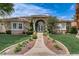 Charming single-story home boasts a landscaped front yard and inviting walkway to the front door at 2500 Wimbledon Dr, Las Vegas, NV 89107