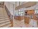 Expansive kitchen with a large island, a cozy breakfast nook, and a connecting staircase at 2500 Wimbledon Dr, Las Vegas, NV 89107