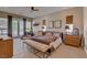 Bright main bedroom with multiple windows, sitting area, and plush carpet flooring at 2500 Wimbledon Dr, Las Vegas, NV 89107
