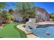 Backyard featuring a sparkling pool with fun basketball hoop and artificial turf at 2500 Wimbledon Dr, Las Vegas, NV 89107