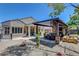 Beautiful backyard with an outdoor kitchen, covered dining area, and desert landscaping for easy maintenance at 2687 Ivoryhill St, Las Vegas, NV 89135