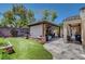 Lush backyard with a covered patio, built-in seating, and outdoor kitchen perfect for gatherings and relaxation at 2687 Ivoryhill St, Las Vegas, NV 89135
