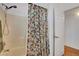 Bright bathroom featuring a shower over tub with a floral shower curtain at 2687 Ivoryhill St, Las Vegas, NV 89135