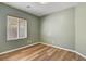 Cozy bedroom with hardwood floors, window with blinds, and neutral paint at 2687 Ivoryhill St, Las Vegas, NV 89135