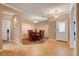 Elegant dining area featuring hardwood floors, archway accents, and stylish chandelier at 2687 Ivoryhill St, Las Vegas, NV 89135