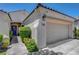 Inviting home exterior with a cozy entryway, desert landscaping, and a two-car garage at 2687 Ivoryhill St, Las Vegas, NV 89135