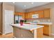 Kitchen boasting an island, stainless appliances, and light wood cabinets at 2687 Ivoryhill St, Las Vegas, NV 89135