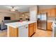 Kitchen with island, stainless appliances, open to living and dining areas at 2687 Ivoryhill St, Las Vegas, NV 89135
