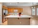 Kitchen featuring an island, stainless appliances, and light wood cabinets at 2687 Ivoryhill St, Las Vegas, NV 89135