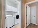 Well-equipped laundry room featuring a washer, dryer, and overhead cabinets at 2687 Ivoryhill St, Las Vegas, NV 89135