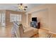 A living room with tile floors, ceiling fan, and plantation shutters at 2687 Ivoryhill St, Las Vegas, NV 89135