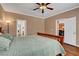 Cozy main bedroom with wood-look floors, neutral walls, and a ceiling fan at 2687 Ivoryhill St, Las Vegas, NV 89135