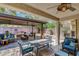 Inviting covered patio with comfortable seating, ceiling fans, and an outdoor dining area for relaxing and entertaining at 2687 Ivoryhill St, Las Vegas, NV 89135