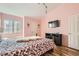 Bedroom with pink walls, hardwood floors, TV, white trim and decor, plus a large window at 2725 S Nellis Blvd # 2084, Las Vegas, NV 89121
