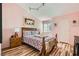Bedroom with wooden floors, king bed, side tables, bear wall art and natural lighting at 2725 S Nellis Blvd # 2084, Las Vegas, NV 89121