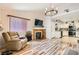 Inviting living room with hardwood floors, fireplace, tv, chair, with kitchen in the background at 2725 S Nellis Blvd # 2084, Las Vegas, NV 89121