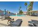 Relaxing community pool area with lounge chairs and palm trees offering ample sunshine at 2725 S Nellis Blvd # 2084, Las Vegas, NV 89121