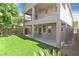 Multi-story home with a backyard featuring an artificial lawn and a small garden at 2864 Kinknockie Way, Henderson, NV 89044