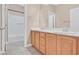 Bright bathroom featuring dual sinks, updated cabinetry, and bathtub at 2864 Kinknockie Way, Henderson, NV 89044