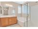 Bathroom with a double vanity, separate bathtub and shower, and tiled floors at 2864 Kinknockie Way, Henderson, NV 89044
