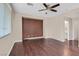 Spacious bedroom featuring hardwood floors, a ceiling fan, and a neutral color palette at 2864 Kinknockie Way, Henderson, NV 89044
