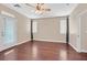 Well-lit bedroom with hardwood floors, a ceiling fan, and a door that leads to the backyard at 2864 Kinknockie Way, Henderson, NV 89044
