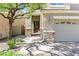 Inviting front entrance featuring a two-car garage, stone accents, and a brick walkway at 2864 Kinknockie Way, Henderson, NV 89044
