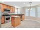 Bright kitchen featuring stainless steel appliances, island, and tile flooring at 2864 Kinknockie Way, Henderson, NV 89044
